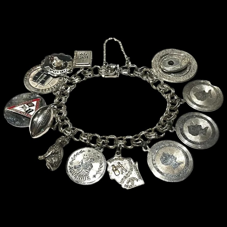 Vintage Muchachos Charm Bracelet: Title: Vintage Muchachos Charm Bracelet Description: Vintage Charm BraceletHallmarked: SterlingWeighs: 62.3 gramsMeasures Approx: 7.5 inches length Reserve: $125.00 Shipping: Domestic: Flat-rate of $6