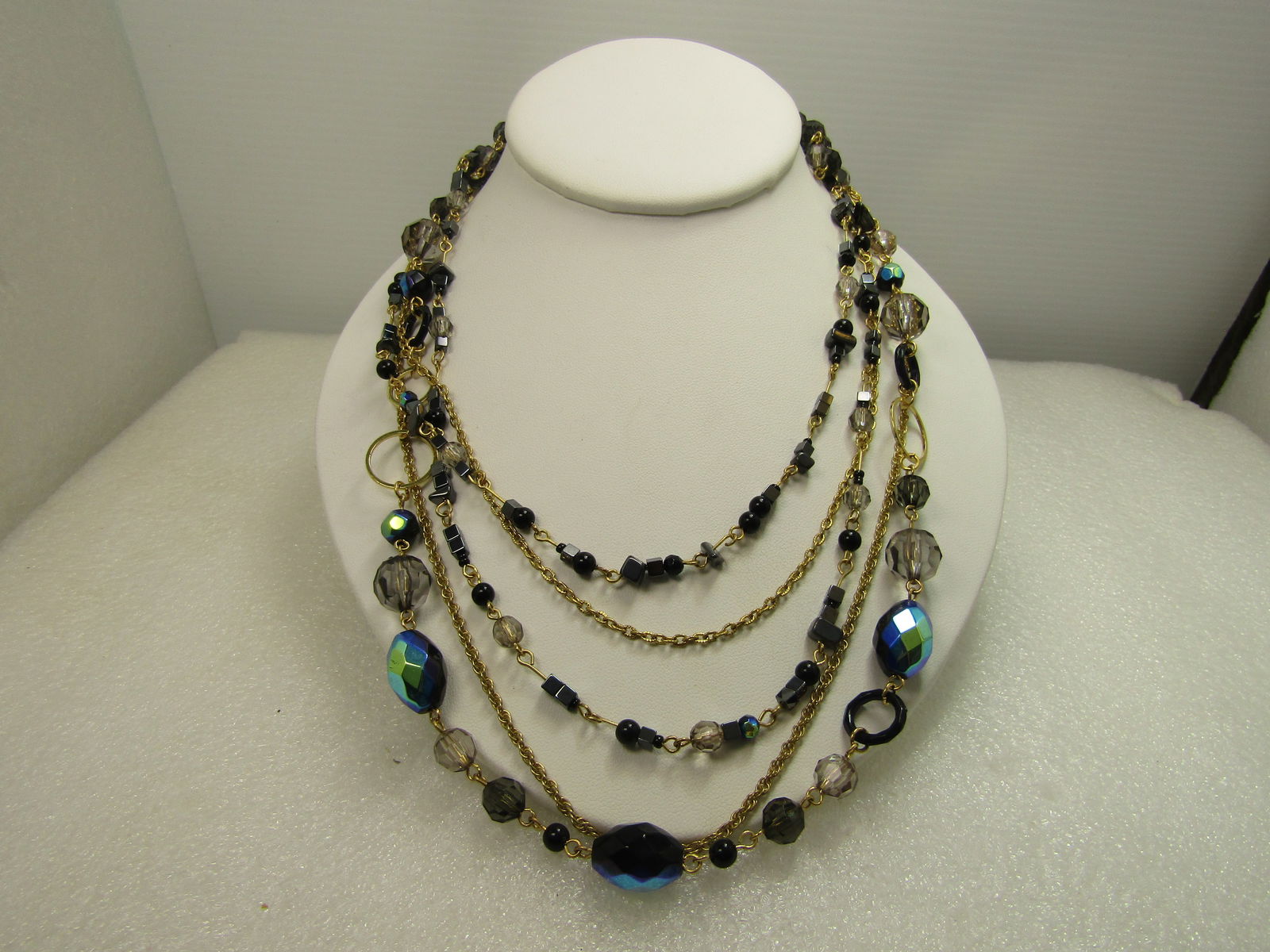 Vintage Five Strand Peacock Hue & Hematite Necklcae, 32", Gold Tone, 1980's-1990's: Vintage Five Strand Peacock Hue & Hematite Necklcae, 32", Gold Tone, 1980's-1990's. This is a mix of glass and acrylic stones in smoky topaz, gray faceted beads with black beads and hematite square