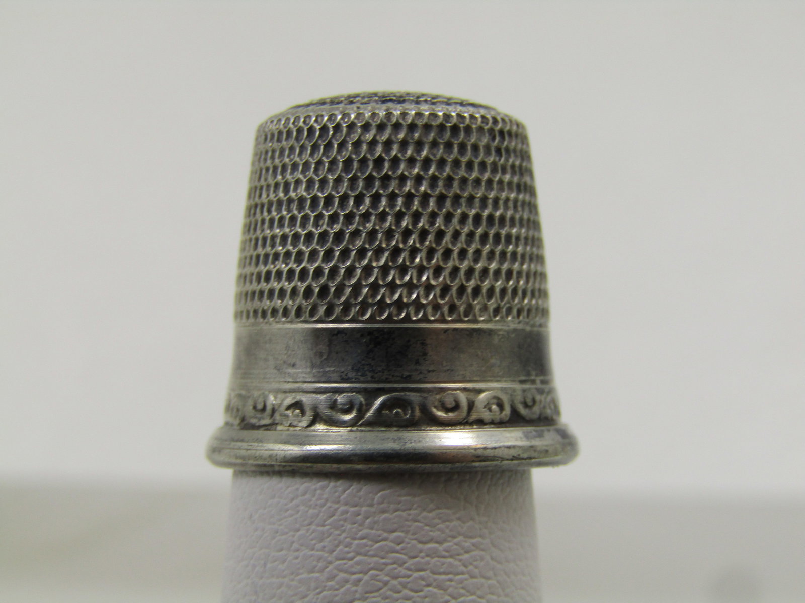 Vintage Sterling Thimble, Sz. 11, Early-1900's, Signed: Vintage Sterling Thimble, Sz. 11, Early-1900's, Signed with what looks like a G and C in the bottom -unknown maker. This has a wider firm band to keep the shape of the opening with a scrolled decorati
