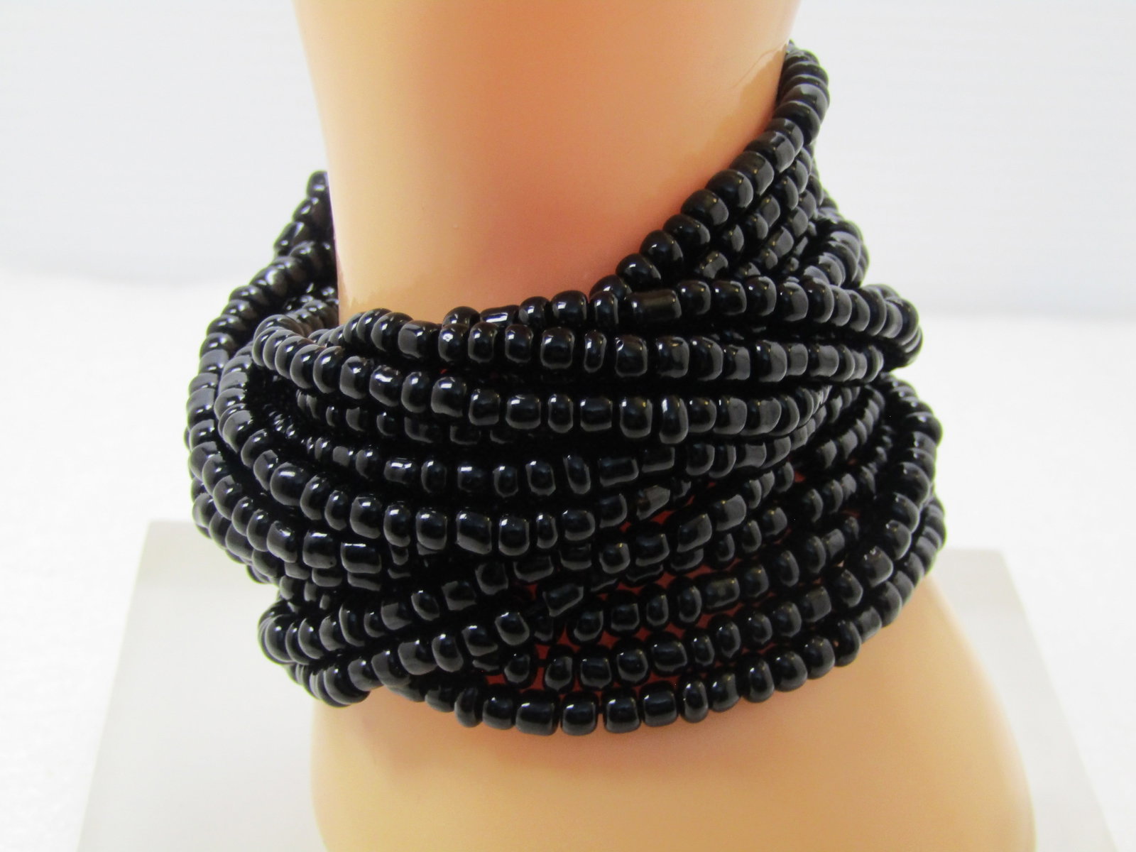 Vintage 16 Strand Black Beaded Bracelet, Wood Wide Clasp, 7.5", 1980's: Vintage 16 Strand Black Beaded Bracelet, Wood Wide Clasp, 7.5", 1980's. Black 4mm seed bead bracelet. It is appx. 2.75" wide. The beads are strung on stretch cord and the end pieces are coved wood wit