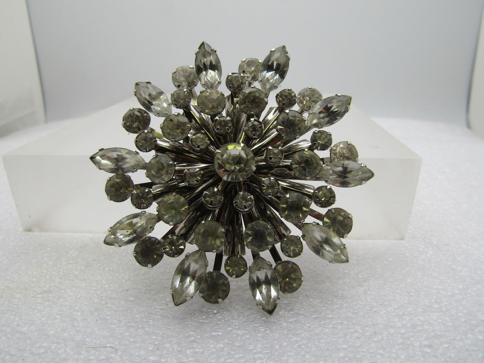 Vintage Rhinestone Tiered Blossom Brooch, 1940's-1960's: Vintage Rhinestone Tiered Blossom Brooch, 1940's-1960's. Silver Tone , six tiers of clear rhinestones in round and marquise cuts. The bottom round stones are appx. 6mm round, pronig-set; the next laye