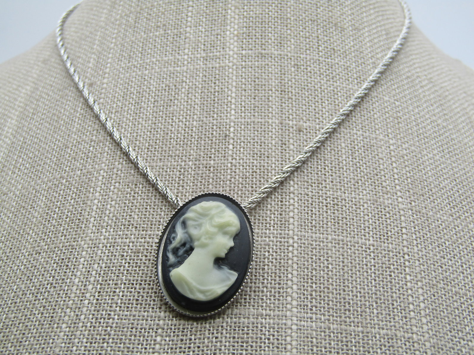 Vintage Cameo Necklace, 15" Monet Chain, 1960's-1970's: Vintage Cameo Necklace, 15" Monet Chain, 1960's-1970's. The cameo is an oval black and white cameo pendant that is appx. 1-1/8" tall and 3/4" wide. The bail is mounted on the back of the cameo. The pe