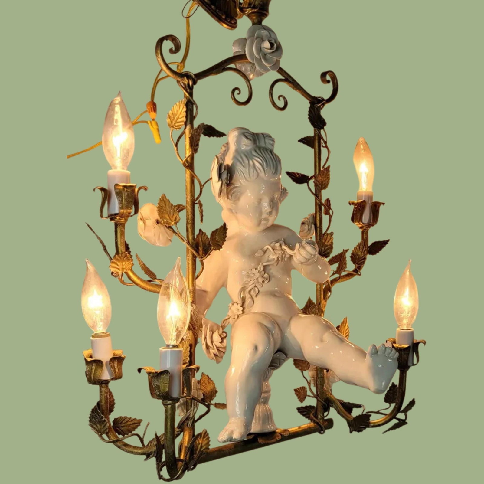 Rococo Revival Cherub Chandelier: Gilt Tole & Porcelain Flowers, 36": Title: Rococo Revival Cherub Chandelier: Gilt Tole & Porcelain Flowers, 36" Description: A stunning mid-20th century Vintage Rococo Revival Chandelier featuring a hand-molded porcelain cherub seated