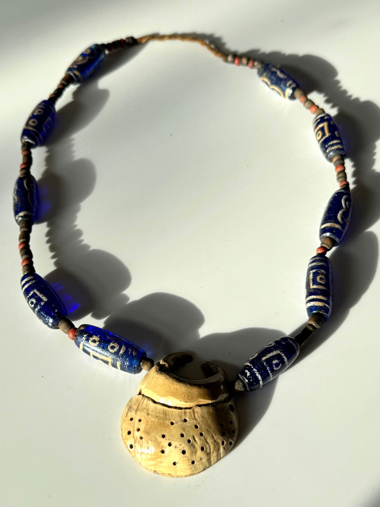 Necklace of Venetian style handmade glass beads from Java Indonesia: Title: Necklace of Venetian style handmade glass beads from Java Indonesia Description: A long strand necklace of Venetian style handmade glass beads and worked out shell from Java Indonesia. Dim: 30