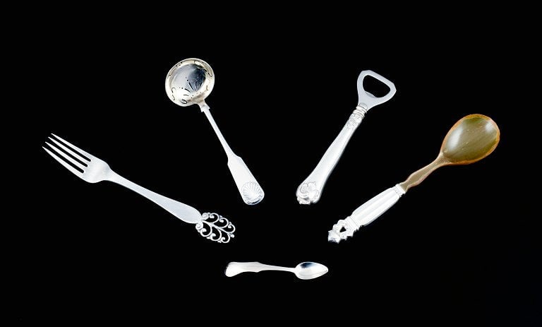 Five pieces of silver cutlery. Georg Jensen and others.: Title:Five pieces of silver cutlery. Georg Jensen and others.Description:Five pieces of silver cutlery. Georg Jensen and others. Georg Jensen Acorn salad spoon, dinner fork, Cohr bottle opener,
