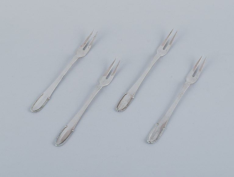 Georg Jensen Beaded. Four cold meat forks in 830 silver.: Title:Georg Jensen Beaded. Four cold meat forks in 830 silver.Description:Georg Jensen Beaded. Four cold meat forks in 830 silver. Early 1915-1930 Hallmark. In excellent condition. Dimensions: L 13.6