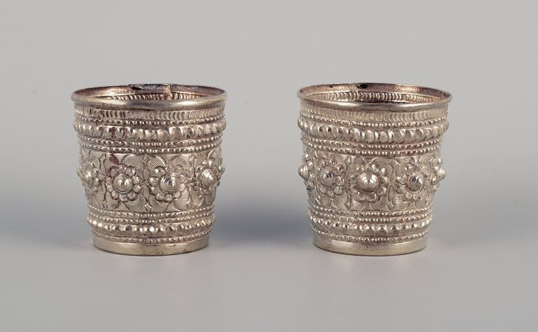 Chinese silversmith. Two small goblets richly decorated in relief with flowers and ornaments. (1 of 5)