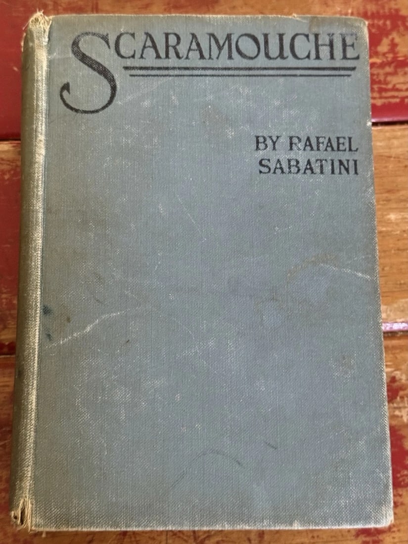 Scaramouche A Romance of the French Revolution Rafael Sabatini 1923 HC Grosset: The product is a first edition 14th impression hardcover book titled "Scaramouche: A Romance of the French Revolution" by Rafael Sabatini, published by Grosset & Dunlap in 1923. It is an original Engl