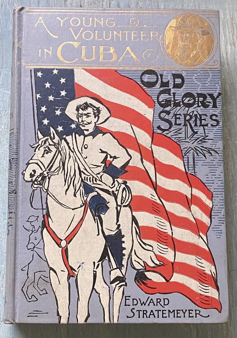 A YOUNG VOLUNTEER IN CUBA by Edward Stratemeyer. First Ed. 1898. Old Glory Ed.: A Young Volunteer In Cuba by Edward Stratemeyer Old Glory Series 1898 Illustrations by A.B. Shute Lee, Lothrop & Shepard Co., Boston Hardcover Blue cloth boards, multicolor illustration to front cover