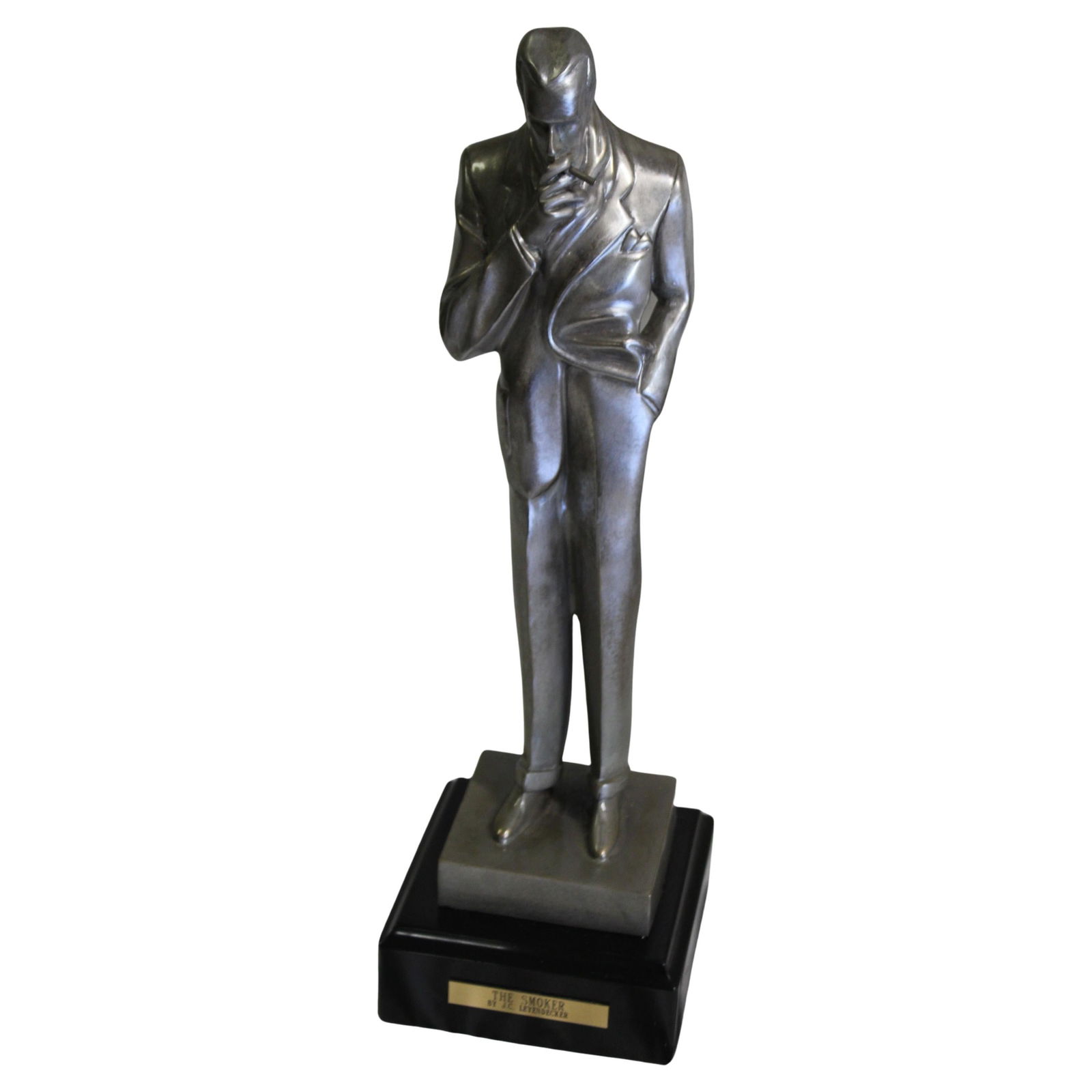 Art Deco Male figure , the Smoker in Silvered Bronze: The most famous figure designed by J.C. Leyendecker Illustration Artist . Known as ( The Smoker ) Cast in lost wax bronze and with a polished Antique Silver patina finish . He stands on an absolute