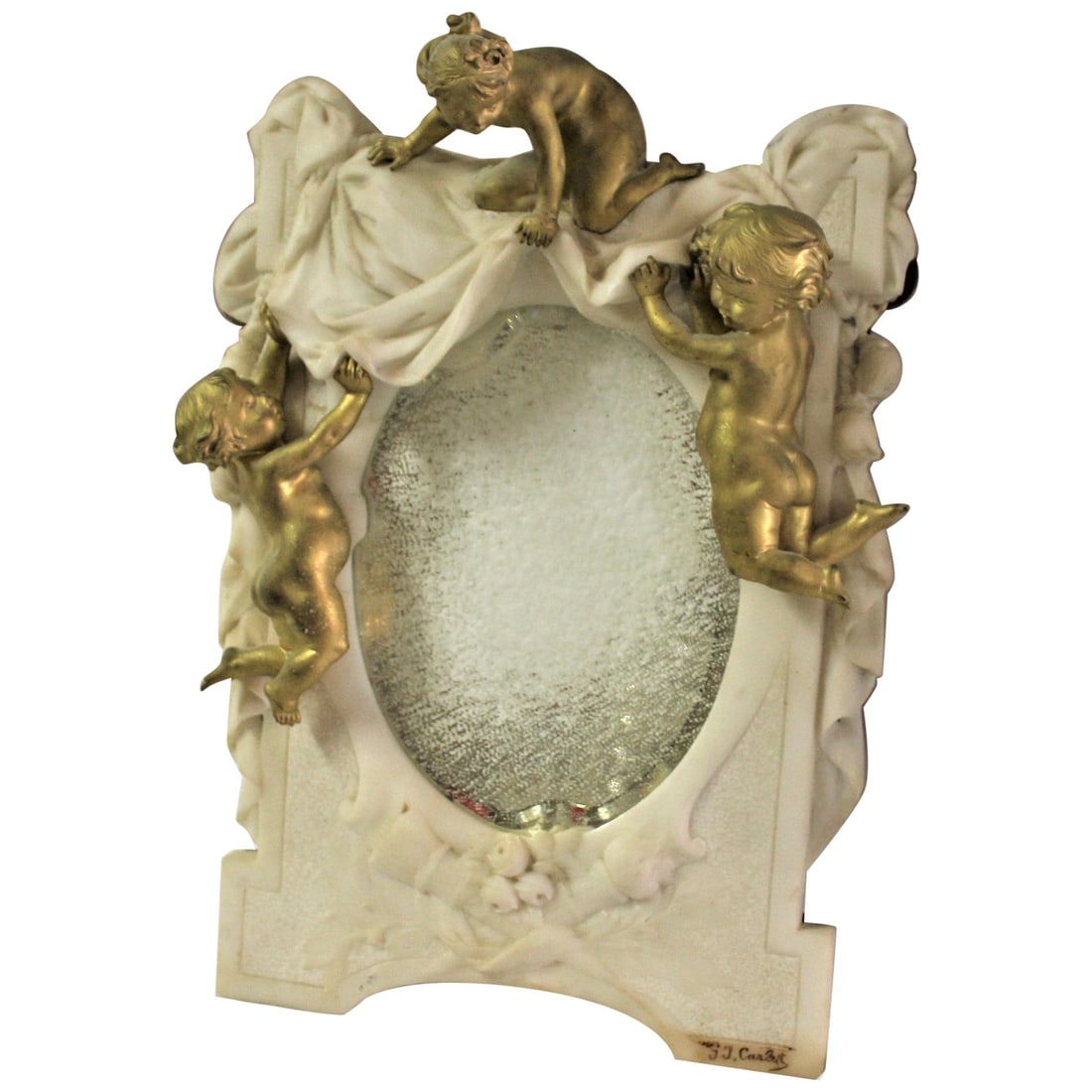 Antique Marble and Cherub Mirror, Doré Gold Finish Signed: A real rare find mirror all hand carved and with 3 gold cherubs crawling over it. All mounted on a wood backing. It is signed in the lower r/h corner (G J. Carley) hard to figure it out. Rubbed to