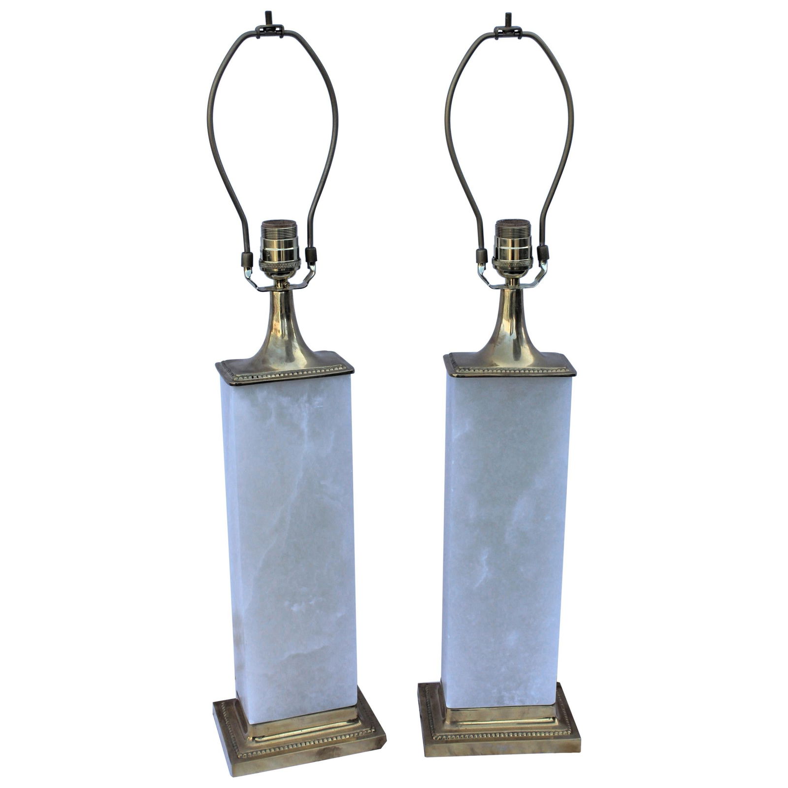 Alabaster Lamps, Solid Blocks, Hi-Polished Brass: A pair of deco / modern looking lamps. Made from solid blocks of Alabaster from Spain. Designed by a LA Lighting Designer . Custom made for his showroom this is the last pair left ,never to be made