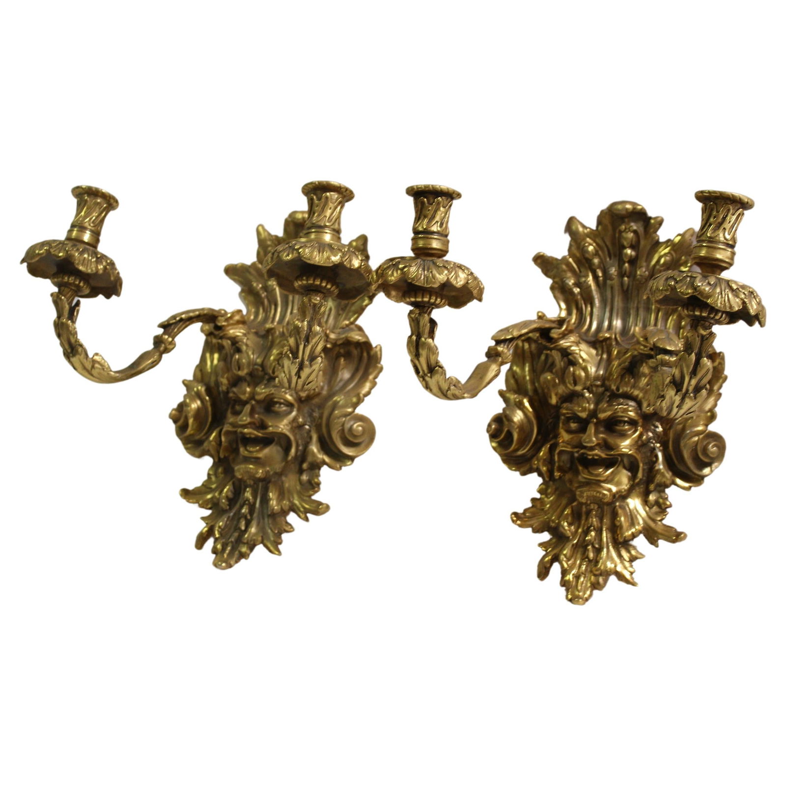 Empire Sconces W Grotesque Man's Face, Gold plate Finish, After Empire, 2 Arms: A rare find of these sconces. Came from Europe and are Contemporary cast in bronze with hi-light in 18 K Gold plating finish. They are for candles and only had a hook on the back for hanging. These