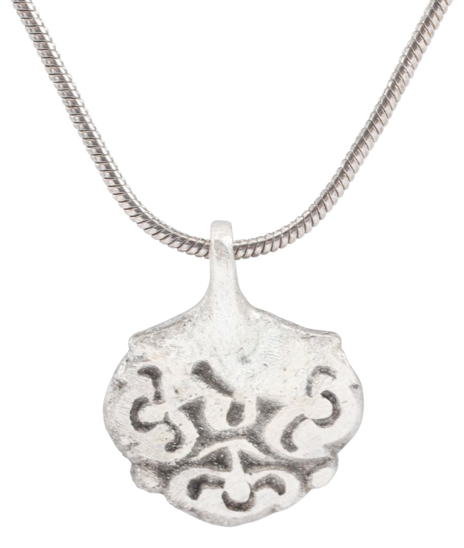 ITALIAN GOTHIC LADY’S PENDANT NECKLACE C.1300-1500: Gilt bronze, of stylized heart form, comprised of a cluster of three floral, perhaps lotus, buds. Full thick section with irregular flat back, produced by the lost wax molding technique. Silvered