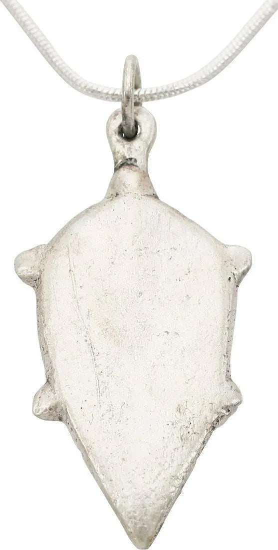 MEDIEVAL SCANDINAVIAN PENDANT: Post Viking, dating about 1200 AD. Form deriving directly from the earlier heart pendants, pointed oval medially ridged as a heart in its anatomical form. Quartered nubs defining a saltire and