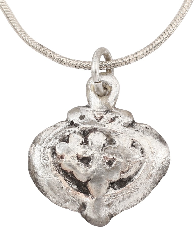 ANCIENT VIKING HEART PENDANT NECKLACE, C.866-1067 AD: Silvered bronze. Just under ¾” (0.72”) width. Broad heart form with central incised trefoil of especially elaborate and stylized configuration. High domed form with rounded edges. Made by the