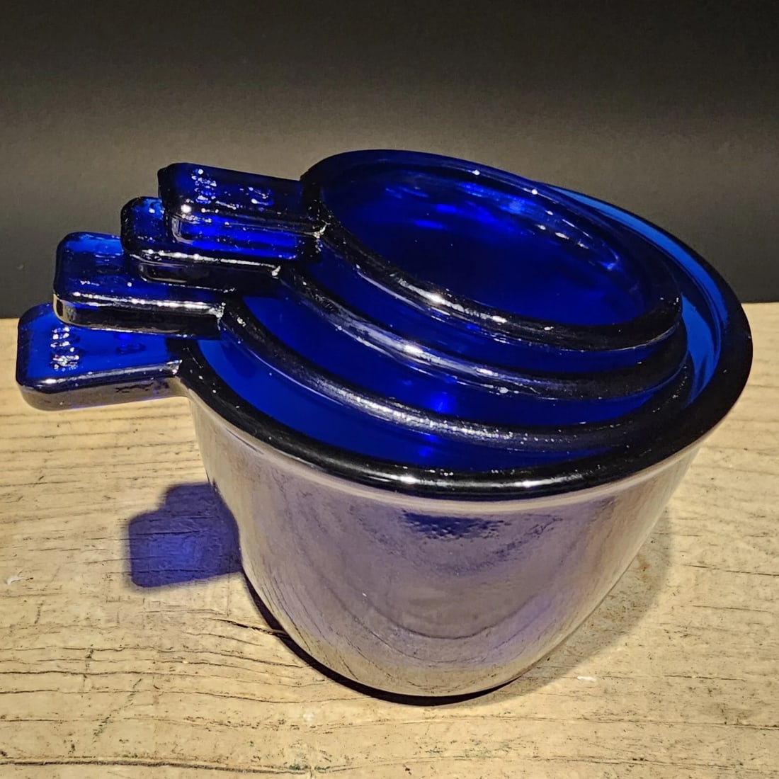 Cobalt Blue Depression Glass 4pc Measuring Cup Set: Sizes – 1 Cup, 1/2 Cup, 1/3 Cup & 1/4 Cup Wonderful reproduction set of measuring cups. A beautiful addition to any collection. The vibrant cobalt blue color and depression-style design make it