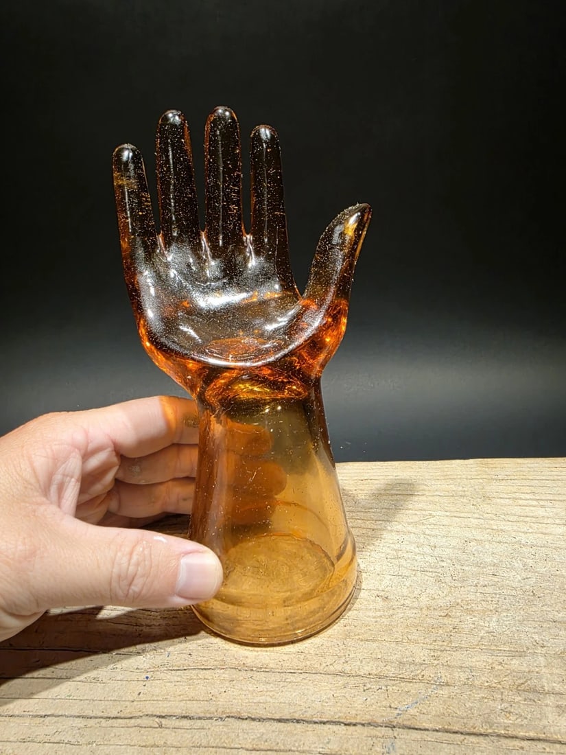 Amber Glass Hand Depression Ring/Glove holder: 8" Tall 4" Wide Wonderful reproduction Amber glass hand ring holder. Beautiful display for decoration or use. The wonderful deep amber color really catches your eye, certainly a must-have for any