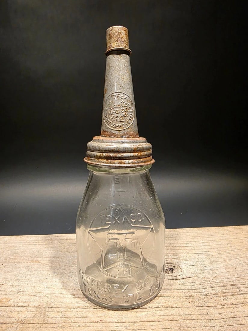 11" Service Station Glass Texaco Oil Bottle w Spout: 11" Tall 4" Wide Glass Oil Bottle with Metal Spout – Early Service Station Style Such a neat reproduction glass oil bottle. Wonderful signs of wear and distress. Hard to tell its age! Reserve:
