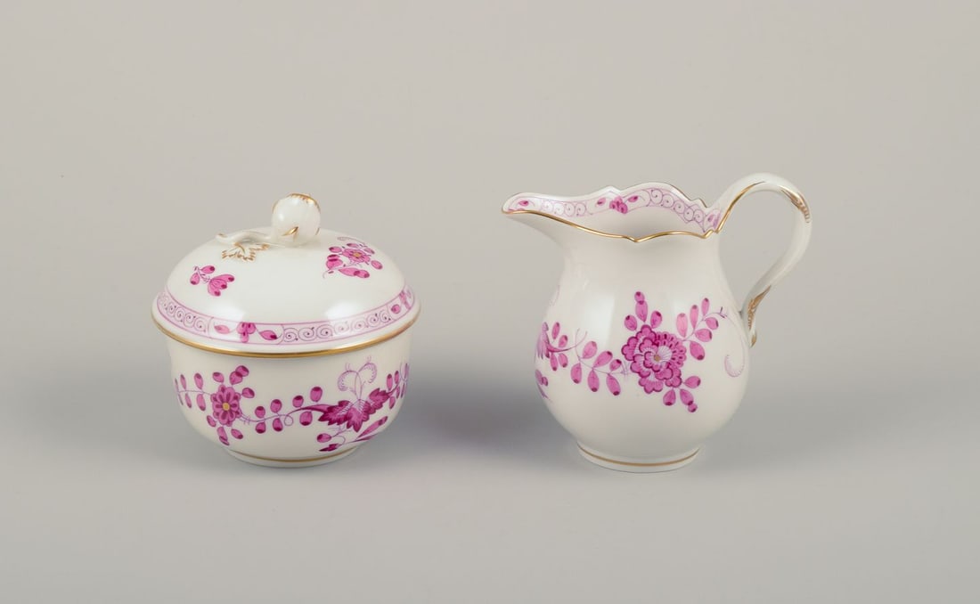 Meissen, Germany. "Pink Indian" porcelain creamer and sugar bowl with purple floral motifs, gold: Title: Meissen, Germany. "Pink Indian" porcelain creamer and sugar bowl with purple floral motifs, gold rim. Mid-20th C. Description: Meissen, Germany. A "Pink Indian" porcelain creamer and sugar