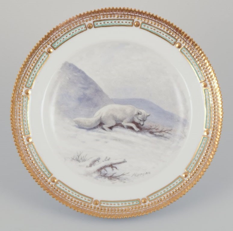 Royal Copenhagen Fauna Danica, porcelain dinner plate with a motif of arctic fox.: Title: Royal Copenhagen Fauna Danica, porcelain dinner plate with a motif of arctic fox. Description: Royal Copenhagen Fauna Danica, porcelain dinner plate featuring a motif of an arctic fox. Gold rim