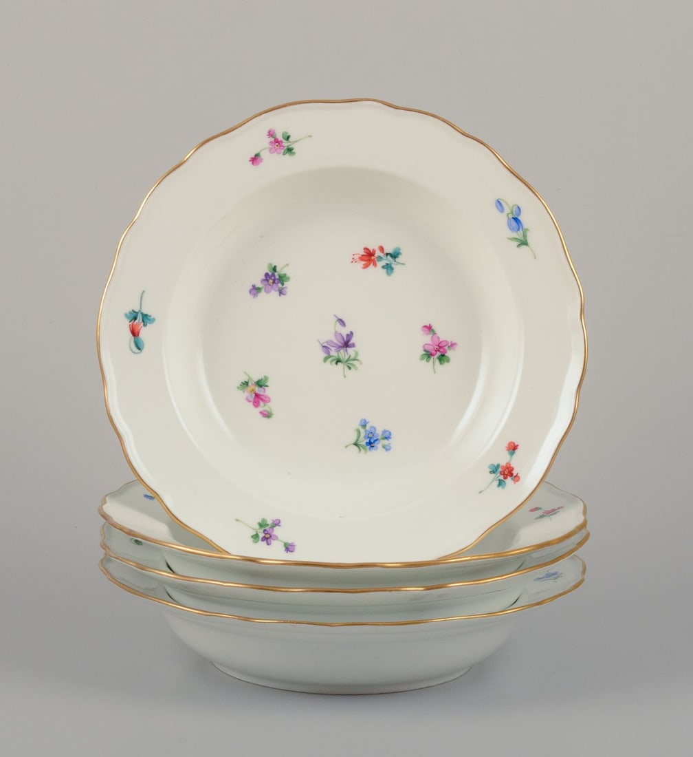 Meissen, Germany. A set of four deep plates in porcelain with polychrome floral motifs and gold rim. (1 of 8)
