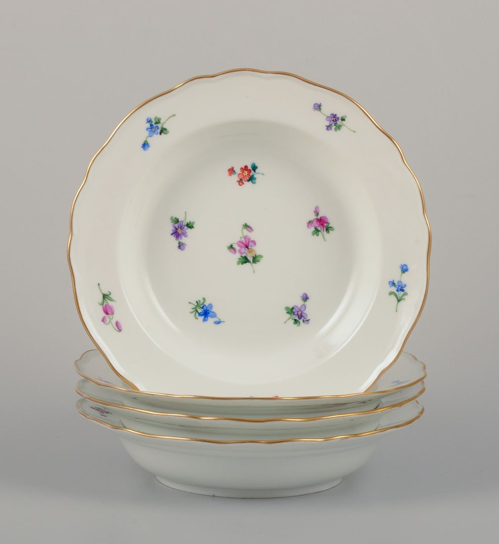 Meissen, Germany. A set of four deep plates in porcelain with polychrome floral motifs and gold rim. (1 of 8)