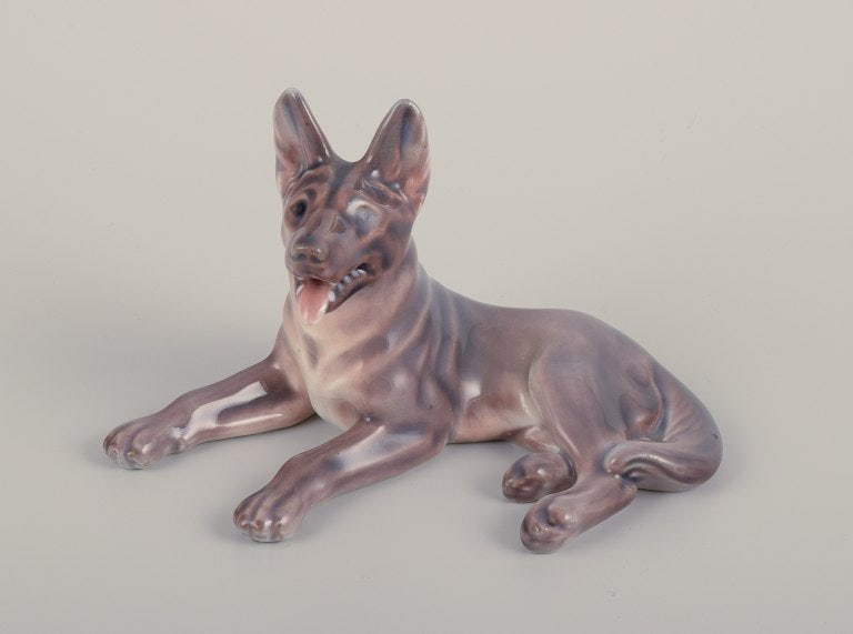 Dahl Jensen, porcelain figurine of a reclining German Shepherd.: Title: Dahl Jensen, porcelain figurine of a reclining German Shepherd. Description: Dahl Jensen, porcelain figurine of a reclining German Shepherd. Model number 1130. Approximately from 1930. Marked.