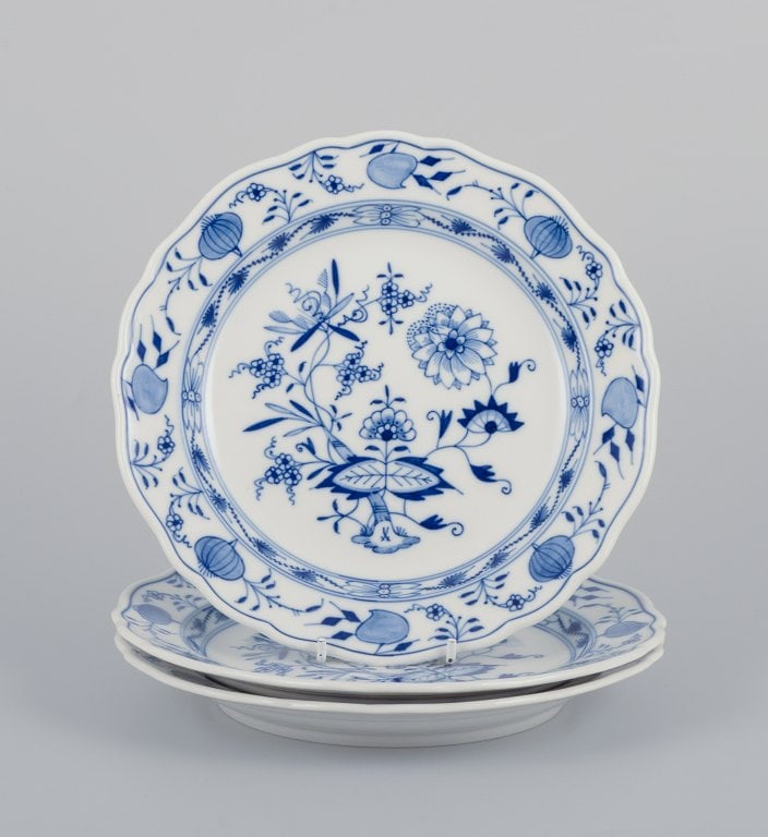 Meissen, three Blue Onion-patterned plates. Hand-decorated with flowers.: Title: Meissen, three Blue Onion-patterned plates. Hand-decorated with flowers. Description: Meissen, Germany, three Blue Onion-patterned plates. Hand-decorated with flowers. Mid-20th century.