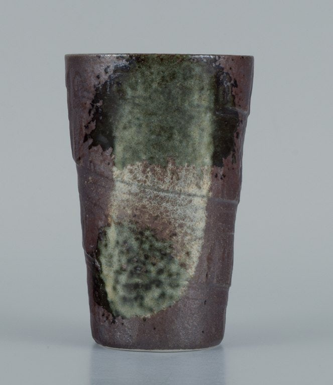European studio ceramicist. Unique vase in green and white glaze on a brown background.: Title: European studio ceramicist. Unique vase in green and white glaze on a brown background. Description: European studio ceramicist. Unique vase in green and white glaze on a brown background. 