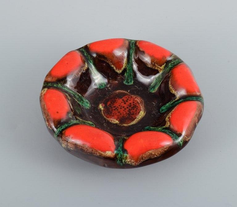 Vallauris, France, three ceramic bowls in brightly colored glazes in red and green on a dark base. - 2