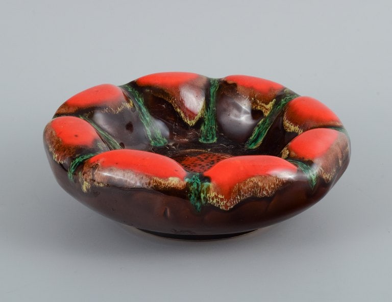 Vallauris, France, three ceramic bowls in brightly colored glazes in red and green on a dark base. - 3
