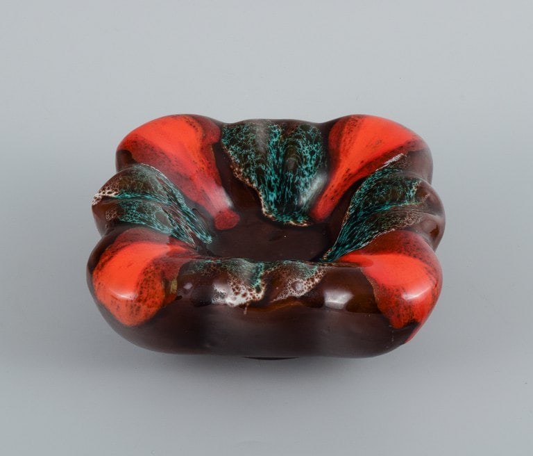 Vallauris, France, three ceramic bowls in brightly colored glazes in red and green on a dark base. - 4