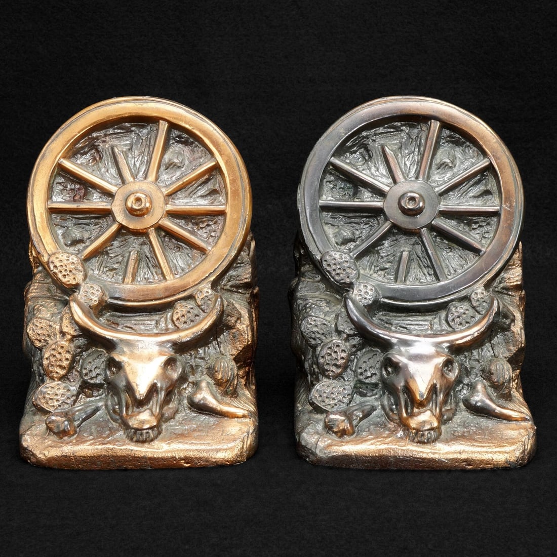 Pair 1930s Wagon Wheel Western Bookends: Title:Pair 1930s Wagon Wheel Western BookendsSize:3 ½ in (8.9 cm) wide x 3 ¾ in (9.5 cm) deep x 4 7/8 in (12.4 cm) tall.Description:A pair of bookends with a western theme of cacti, cow