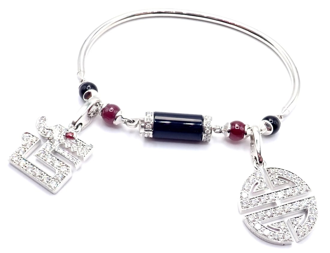 Cartier Le Baiser Du Dragon 18k Gold Diamond Ruby Onyx 2 Charms Bangle Bracelet: Cartier Le Baiser Du Dragon 18k Gold Diamond Ruby Onyx 2 Charms Bangle Bracelet About This Piece: Metal: 18k White Gold Bracelet: Charms: Size 17 Width 7mm Longevity 30mm x 18mm Dragon 27mm x 17mm Wei