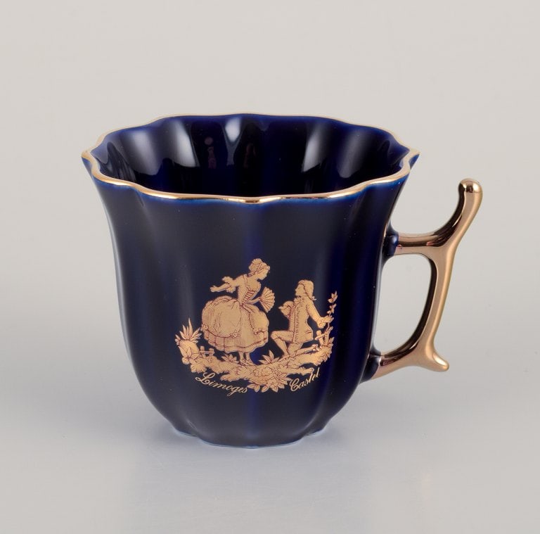 Limoges, France. Two pieces of porcelain consisting of a coffee cup and sugar bowl decorated with - 5