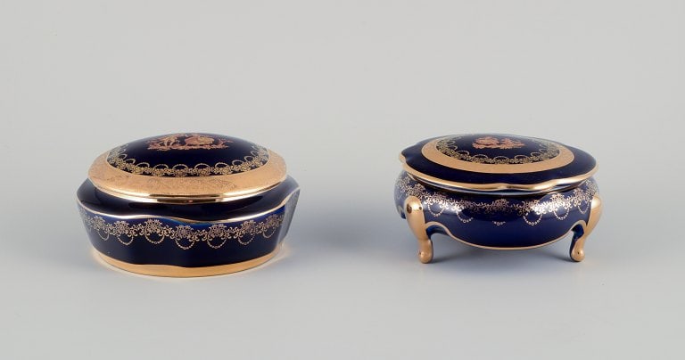 Limoges, France. Two lidded porcelain jars decorated with 22-karat gold leaf and featuring a (1 of 8)