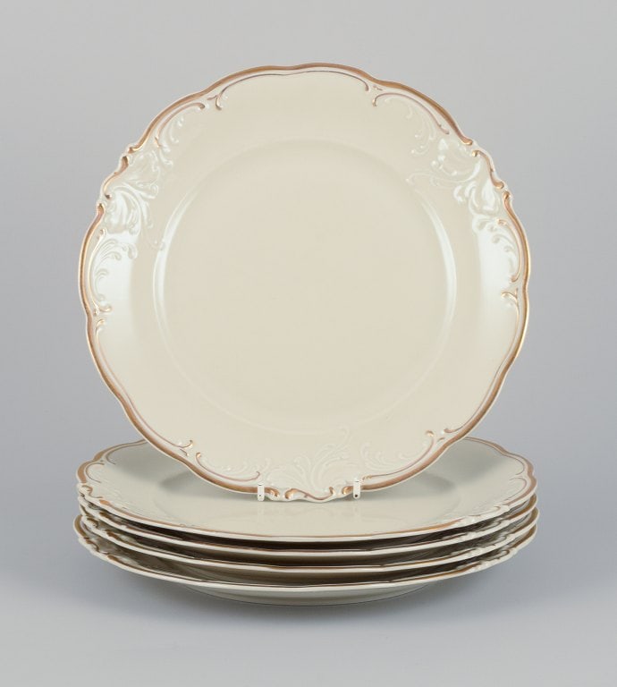 KPM, Poland. A set of five dinner plates in cream-colored porcelain. Decorated with a gold rim. (1 of 6)