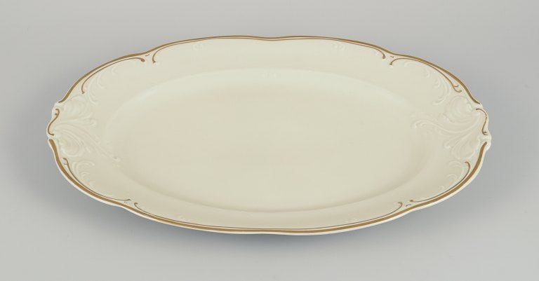 KPM, Poland. Two large oval porcelain serving platters. Cream-colored with gold rim decoration. - 2