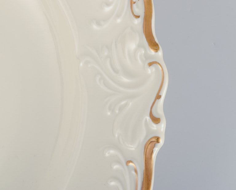 KPM, Poland. A set of four large deep porcelain plates in cream color. Gold-rim decoration. - 4