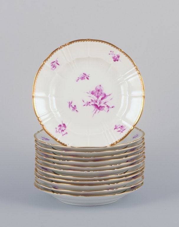 Bing & Grøndahl, Denmark. A set of twelve small plates with flower decorations in purple and (1 of 7)