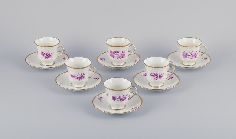 Bing & Grøndahl, Denmark. A set of six coffee cups and saucers with flower decorations in: Title:Bing & Grøndahl, Denmark. A set of six coffee cups and saucers with flower decorations in purple and gold trim. Hand-painted.Description:Bing & Grøndahl, Denmark. A set of six coffee