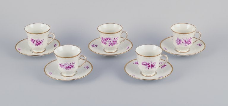Bing & Grøndahl, Denmark. A set of five coffee cups and saucers with flower decorations in: Title:Bing & Grøndahl, Denmark. A set of five coffee cups and saucers with flower decorations in purple and gold trim. Hand-painted.Description:Bing & Grøndahl, Denmark. A set of five