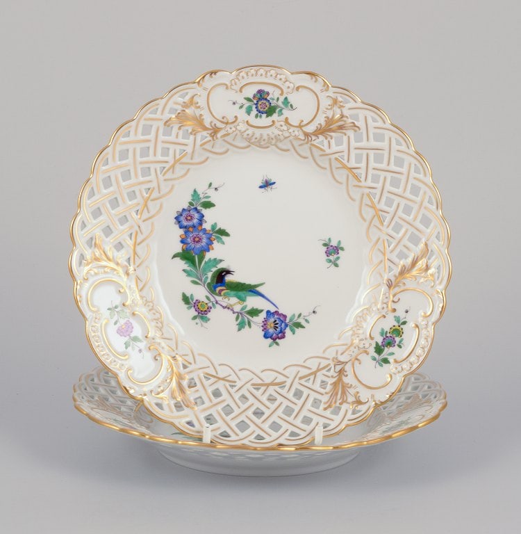 Meissen, Germany. Two open lace plates in porcelain, decorated in gold with an exotic bird on a (1 of 9)