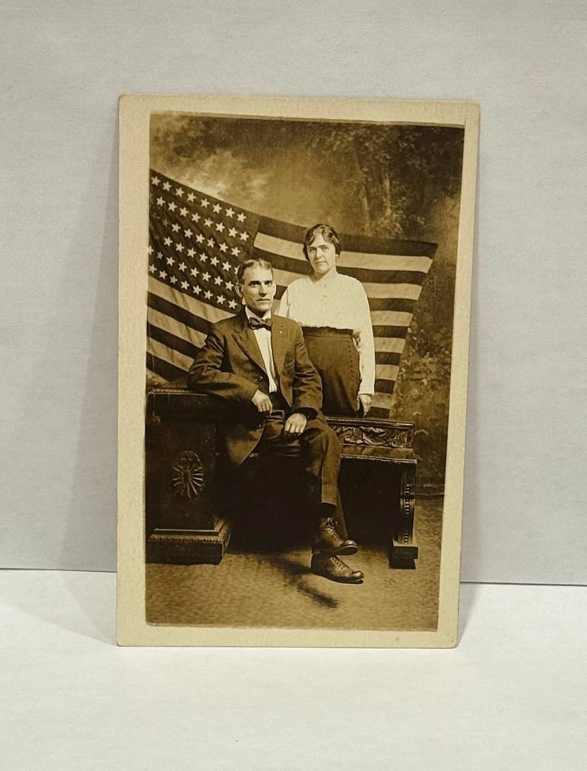 RPPC Real Photo Patriotic Postcard Couple with a Large American Flag 1900 - 2