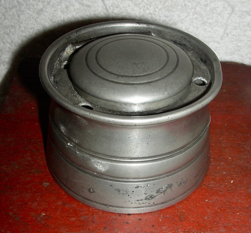Early 19th C Pewter Inkwell: A very early 19th century (possibly late 18th century) Pewter Inkwell, 3” in diameter and 2 ¼” high. Lift-lid and 5 holes to rest pens or quills. Unfortunately, NO insert but the