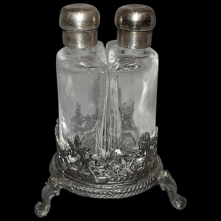 Antique French Double Perfume Bottles with Pewter Stand: This Antique French Double Perfume Bottles with Pewter Stand is in excellent condition. Cork insert is in excellent condition, pewter lids screw on and off, bottles fit tight in stand. Stand has a B