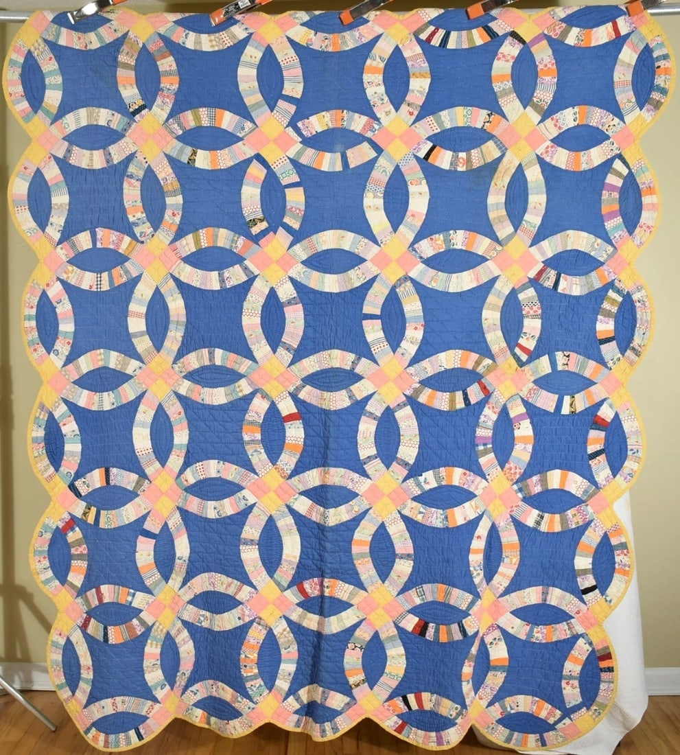 30's Wedding Ring Quilt, Blue Background: This beautiful cotton 30's double wedding ring quilt is all hand pieced and hand quilted, with an unusual solid blue background and attached provenance: "Mother maiden name Lucille Gray born March