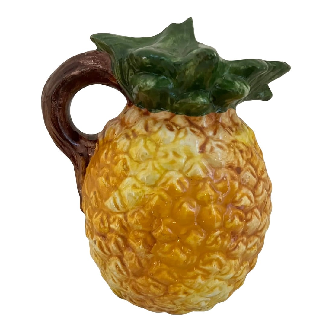 Vintage Italian Pineapple Pitcher: Hand made Italian majolica pineapple pitcher featuring green leaf spout and brown stem handle. Appears to be in display only condition as the original sticker is still attached on the spout. Marked