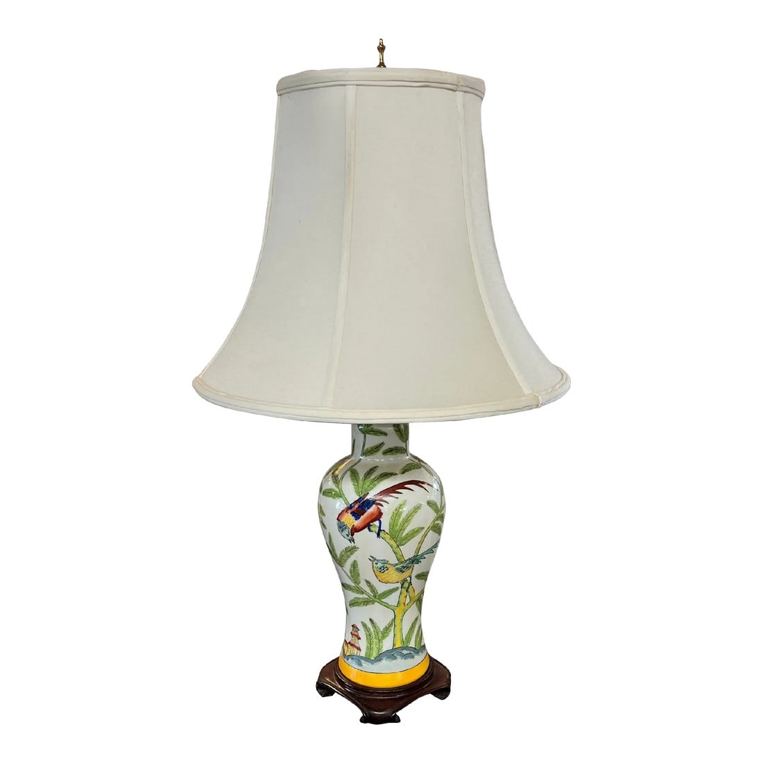Chinoiserie Lamp Depicting Bamboo, Birds and Pagodas, Shade Included: Chinoiserie ceramic lamp depicting birds amid bamboo leaves and pagodas in the background. Background is white with a cheerful design of green, red, blue and yellow. Measures 6" diameter x 29". 